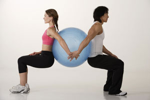 Couple working out with exercise ball - Asia Images Group