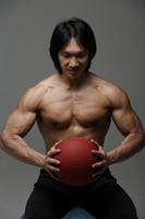 Man holding medicine ball - Asia Images Group