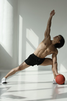 man working out with medicine ball - Asia Images Group