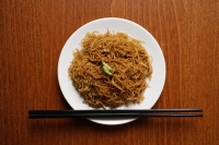 Chinese noodles on plate with chopsticks. - Asia Images Group