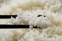 close up chopstick holding rice - Asia Images Group