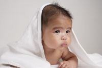 Chinese baby with towel over his head. - Asia Images Group