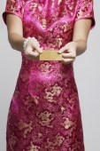 cropped shot of woman in pink cheongsam - Asia Images Group