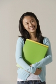 young woman holding folder - Asia Images Group