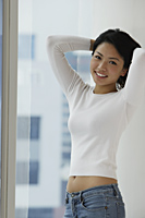 Young Asian woman holding up hair - Asia Images Group