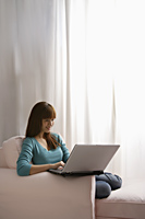 Asian girl with laptop at home - Asia Images Group