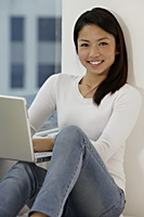 Young Asian woman working on laptop - Asia Images Group