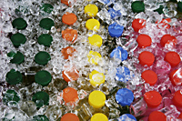 Colorful juice bottles covered in ice - Asia Images Group