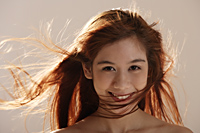 Asian girl with wind blown hair - Asia Images Group