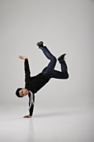 Man break dancing on floor - Asia Images Group