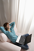 Asian girl relaxing at home with laptop - Asia Images Group