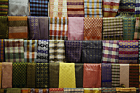 Bright colored sarongs hanging at a market - Asia Images Group