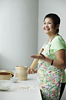Mature Chinese woman making Dim Sum - Asia Images Group