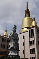 Golden spires and Buddhist Statue - Asia Images Group