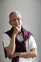head shot of mature man with grey hair thinking - Asia Images Group