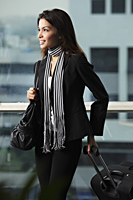 Young woman holding bag and pulling suitcase - Asia Images Group