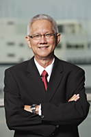 mature man with grey hair wearing a suit and smiling - Asia Images Group