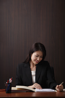 Woman working at her desk - Asia Images Group