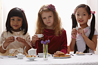 Three young girls having a tea party - Asia Images Group