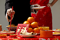 Crop shot of someone getting food during Chinese New Year party. - Asia Images Group