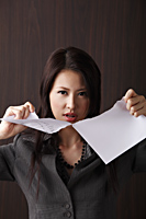 woman ripping paper - Asia Images Group