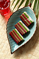 Nine layer cake (Kueh) on leaf plate. Traditional Malay dessert - Asia Images Group