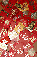 many different Hong Baos, red envelope scattered on table. - Asia Images Group