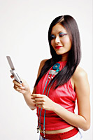 Young woman looking at mobile phone - Asia Images Group