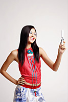 Young woman looking at mobile phone, smiling - Asia Images Group