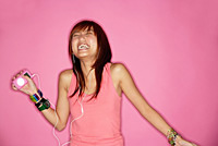 Young woman with mp3 player, laughing - Asia Images Group