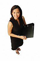 Woman with document binder, looking up at camera - Asia Images Group