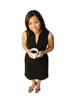 Woman with coffee cup, looking up at camera - Asia Images Group