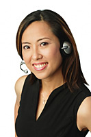 Woman using headset, smiling at camera - Asia Images Group
