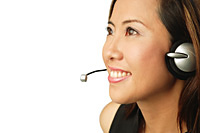 Woman using headset, looking away, portrait - Asia Images Group