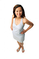 Woman with hands on hips, looking up at camera - Asia Images Group