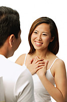 Woman with hands on chest, facing man - Asia Images Group