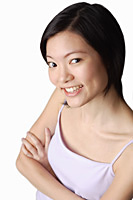 Young woman looking at camera, smiling, arms crossed - Asia Images Group