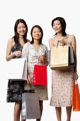 Three young women holding shopping bags - Asia Images Group