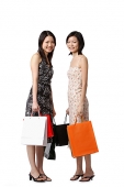 Two young women carrying shopping bags - Asia Images Group