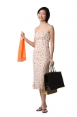 Young woman carrying shopping bags, portrait - Asia Images Group