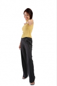 Young woman standing, hand pointing towards camera - Asia Images Group