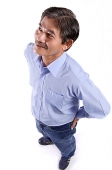 Mature man looking away, hands on hips - Asia Images Group