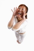 Woman standing, hands on face, shouting - Asia Images Group