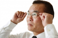 Businessman adjusting glasses, side view - Asia Images Group
