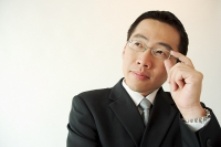  Businessman adjusting glasses - Asia Images Group