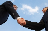 Businessmen shaking hands, low angle view - Asia Images Group