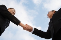 Two businesswoman shaking hands, low angle view - Asia Images Group
