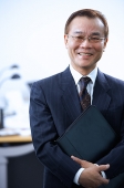 Businessman with binder, looking at camera, portrait - Asia Images Group