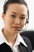 Executive with headset, looking at camera - Asia Images Group