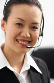 Woman with headset, looking at camera - Asia Images Group